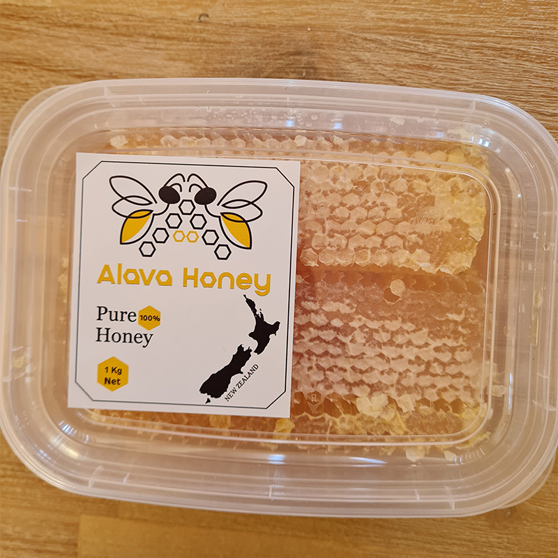 Top view of one plastic tub filled with honeycomb and Alava Honey logo